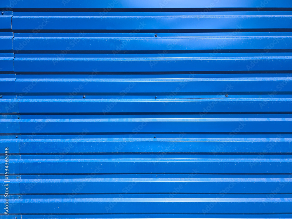 Obraz premium Metallic texture surface. Iron corrugated blue fence. Background material of tin wall. Blue corrugated metal texture surface wall or galvanized steel wall of industrial building