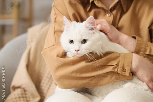 Woman with cute white cat a...