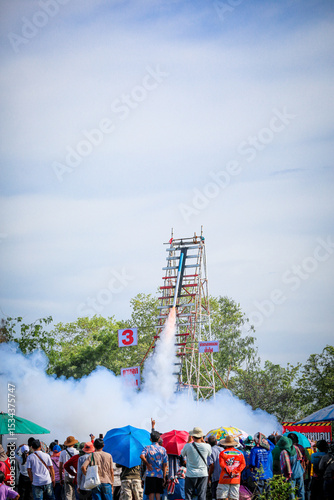Fototapeta Naklejka Na Ścianę i Meble -  Yasothon, Thailand -18 May 2025 : Yasothon Rocket Festival Lighting rockets is a ritual asking for rain to the gods to get water for agriculture. according to local beliefs joyful atmosphere,to local