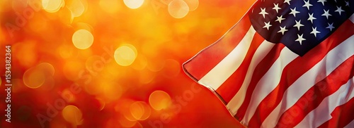 American flag waving against a vibrant orange bokeh background