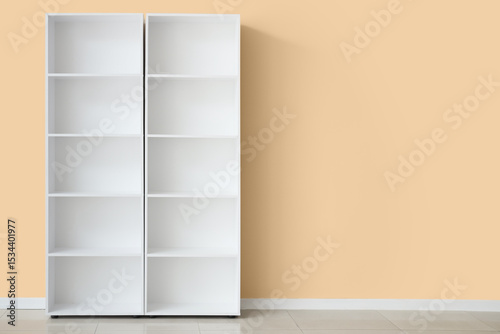 Empty white shelf unit near beige wall in room