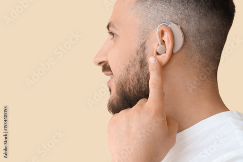 Young man with hearing aid ...