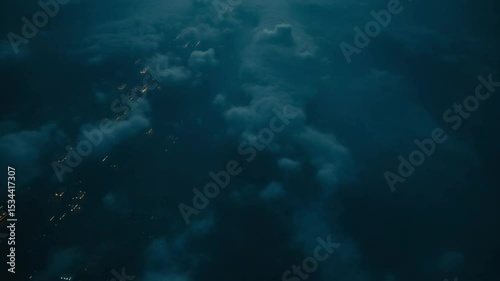 City lights glimpsed through a cloudy night sky