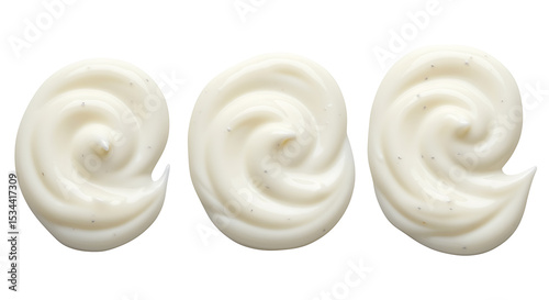 Three swirls of creamy white substance against a clean white background displaying texture