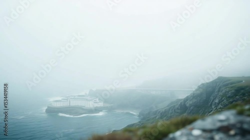 Coastal building obscured by fog bridge backdrop