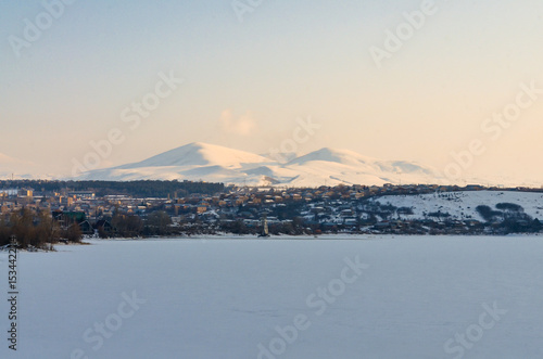 ice-covered Tsovinar Lake and Menaksar Mountain scenic view in winter (Hrazdan, Armenia)