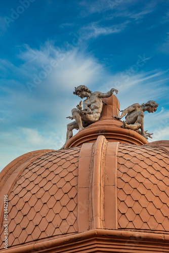 Statues atop a Dome at Sunset in Bucharest, Romania