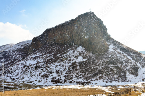 cross on snow covered cliffs of Hrazdan river gorge near Bjni (Kotayk province, Armenia)	
