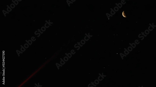 Crimson laser piercing celestial eclipse night