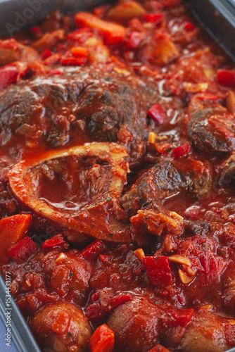 ossobuco stew with vegetables, knuckle on the bone with new potatoes, in tomato sauce,homemade, top view, no people,