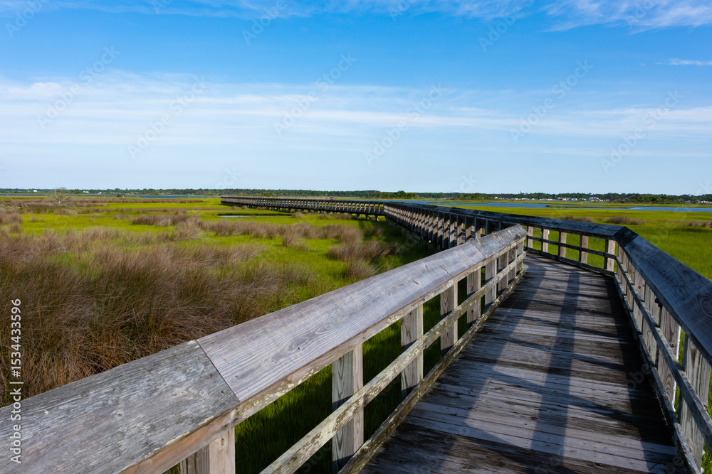 Fototapeta premium A walkway leading out into the intercoastal waterway during a morning walk while on vacation at the beach.