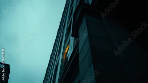 Gloomy teal sky over stark skyscraper