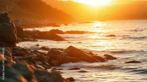Golden hour caressing rocky shoreline waters