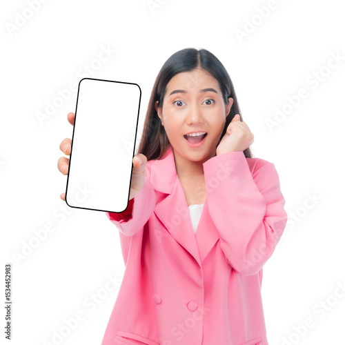 Excited Asian woman in pink suit showing blank smartphone screen, cheerful young female presenting mobile device for app promotion or digital ad, isolated on a transparent background
