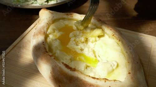 Adjarian Khachapuri with Egg and Butter. Traditional Georgian Cheese Bread