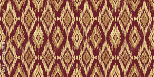Richly patterned textile featuring diamond motifs in red and gold hues.
