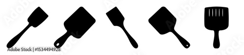 Different styles of kitchen spatulas and spreaders in black and white