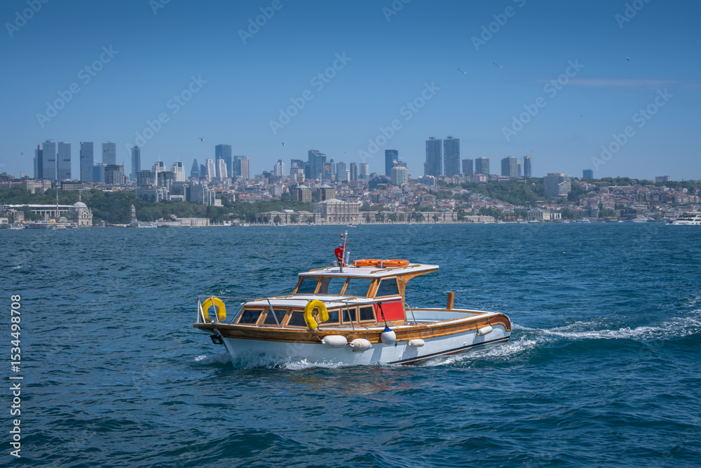Obraz premium Wooden, pleasure and fishing boat. Bosphorus and Istanbul in the background. istanbul, turkey.