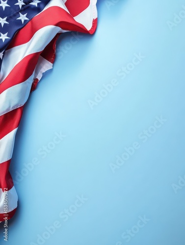 Patriotic American flag corner on soft blue background providing elegant copy space, ideal minimalist image for Memorial Day, Fourth of July greetings, or veteran tributes.