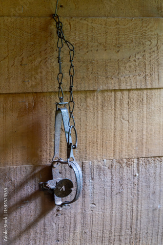An antique rabbit snare hanging on a wall