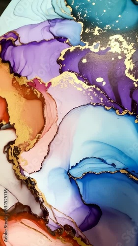 Alcohol ink abstract art background with swirls of blue, purple, pink and gold paints forming fluid artistic patterns and textures