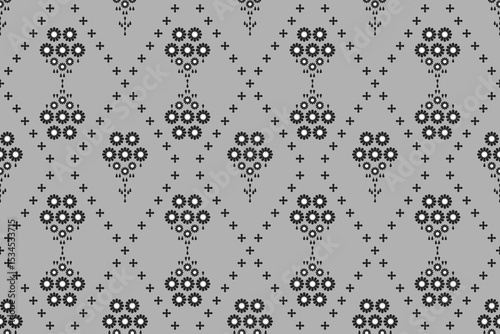 Ethnic flower patterns of black geometric shape on grey background. Textile seamless vector design. Concept of floral, motifs, tribal, vintage, tradition for wallpaper, embroidery, wrap, decor, fabric