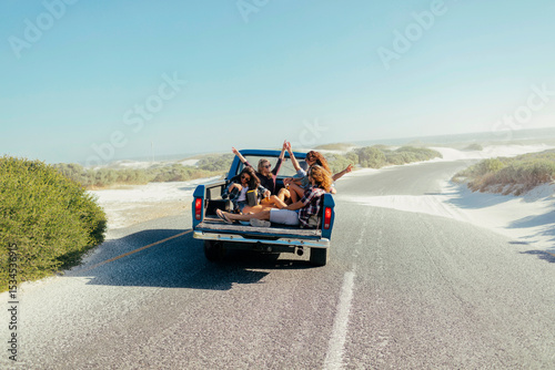 Friends road trip in pickup truck near the beach