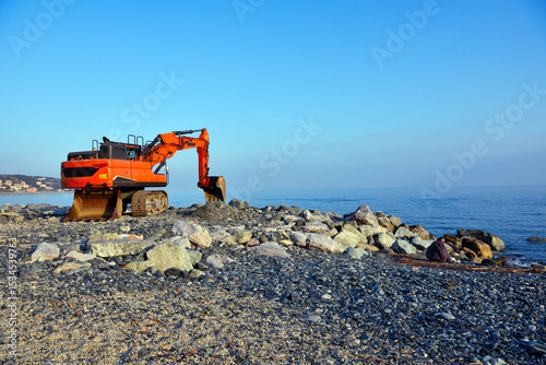 crawler excavator on the beach of cogoleto genoa italy