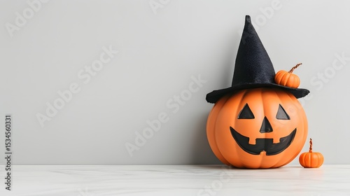 Smiling Halloween pumpkin with black hat and orange mini pumpkins on light background, festive autumn backdrop