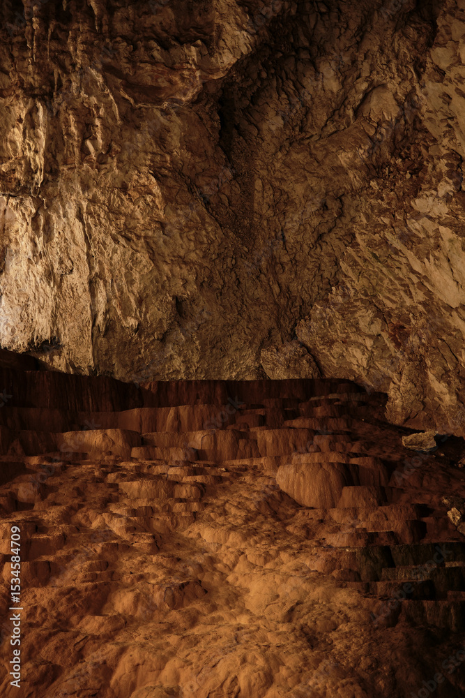 Natural terrace rock formation inside Stopica Cave under warm artificial lighting. Zlatibor, Serbia country. Natural terrace rock formation inside Stopica Cave under warm artificial lighting. Zlatibor, Serbia country.