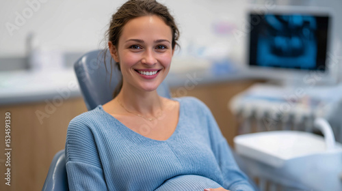Close-up of a cheerful pregnant woman with radiant skin smiling during a dental check-up, calm expression under overhead exam light, baby bump visible