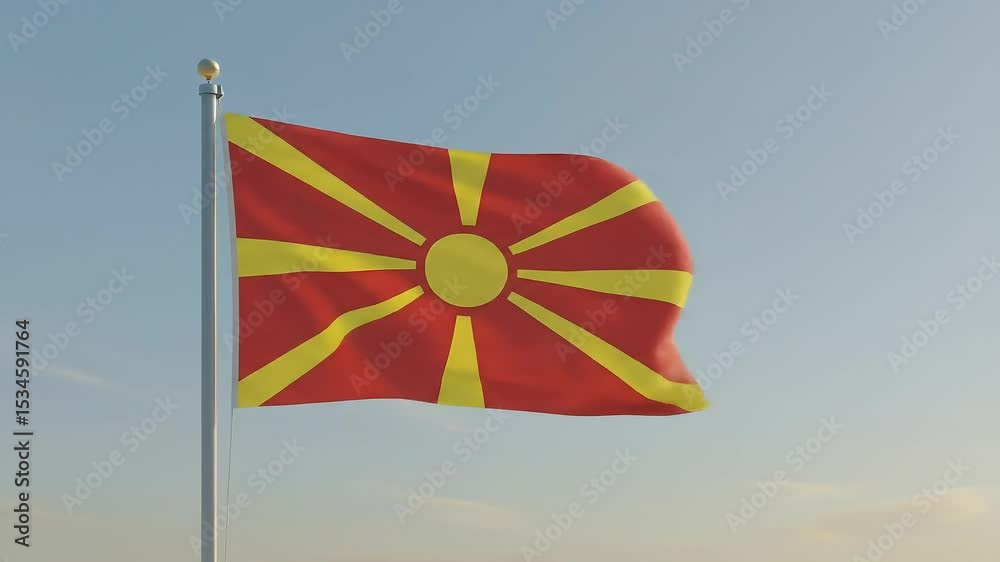 The North Macedonian national flag waving gently in the early morning breeze, centered against a clear, pastel-blue sky.