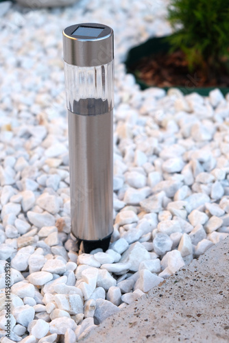 Solar powered lantern close up in landscape design
