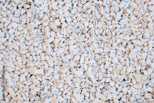 Marble chips, stone for landscape design, top view background.