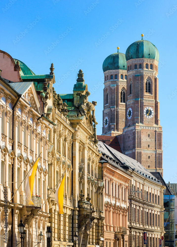 Fototapeta premium Historic European old town and city centre of Munich with a view of Frauenkirche also Munich Cathedral, the central church and tourist attraction of the Bavarian capital - Munich, Germany