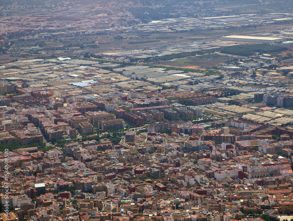 Naklejka premium Vista aérea de edificios de Aldaia, casas de Alaquàs, zona industrial y cultivos, pueblo de Torrent al fondo. Municipios y barrios de Valencia, Comunidad Valenciana, España. Residencial, zonificación 