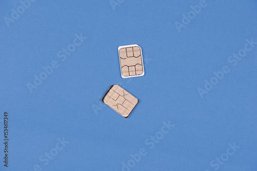 Two phone SIM cards, symbolizing international communication, dual SIM convenience, and staying connected abroad. Concept of global roaming, travel connectivity, e-SIM and modern telecommunications.