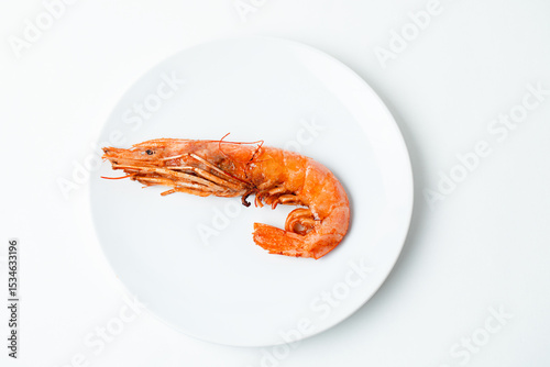 Close up of Red cooked shrimp on plate isolated on a white background. Copy space.