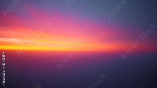 Vibrant sunset with gradient of warm yellow to deep purple, softly blurred landscape at dusk or dawn, horizon line, atmospheric sky.