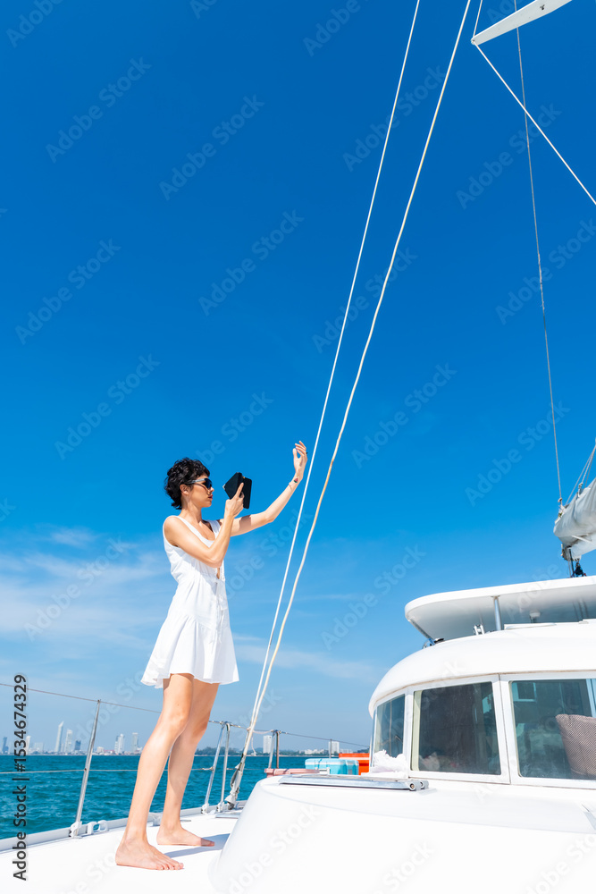 Beautiful Caucasian woman travel nature the sea on luxury catamaran boat yacht on summer beach holiday vacation. Happy woman enjoy using mobile phone taking selfie on cruise ship sailing in the ocean. Beautiful Caucasian woman travel nature the sea on luxury catamaran boat yacht on summer beach holiday vacation. Happy woman enjoy using mobile phone taking selfie on cruise ship sailing in the ocean.