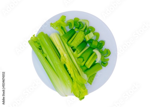 Fresh Celery on the plate heads and some slices raw vegetable celery