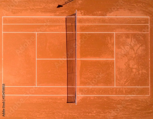 Aerial view of a tennis clay court with clear white lines, rich terracotta texture