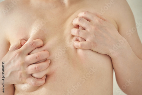 Close-up of caucasian male with skin folds and bare chest, highlighting personal body care.