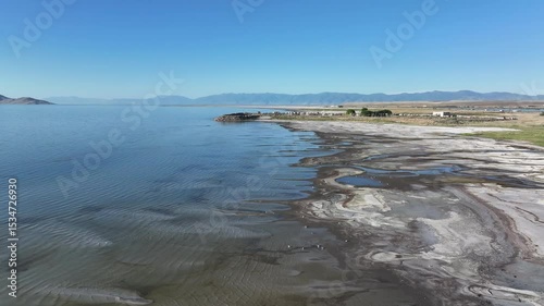 Aerial Great Salt Lake environment to Kennecott. Largest saltwater lake in the Western Hemisphere. Solar evaporation ponds produce salt, potassium, magnesium. Recreation and industry.