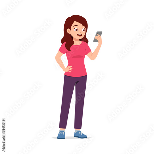 Happy young woman in casual clothes holding smartphone and looking at screen