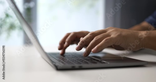 Hands typing on keyboard in minimal workspace