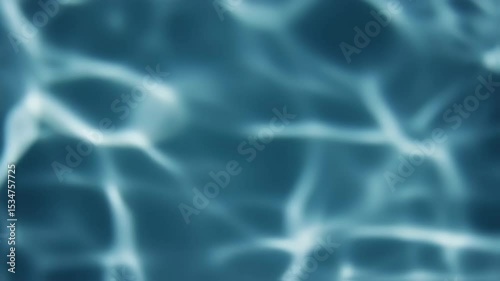 Abstract blue liquid surface with light reflecting and refracting through water, creating shimmering effects