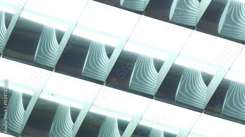 The fluorescent light on the ceiling glows with a cool, blue light.