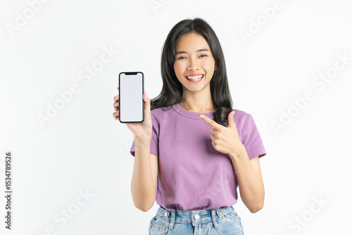 Smiling asian woman holding smartphone with blank screen for advertise on white background.