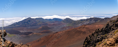 Panoramic view of Haleakala crater with clouds and blue sky in Maui, Hawaii.